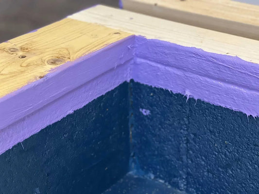 Applying Waterproof Blue liquid damp proof membrane to a basement wall to stop rising damp