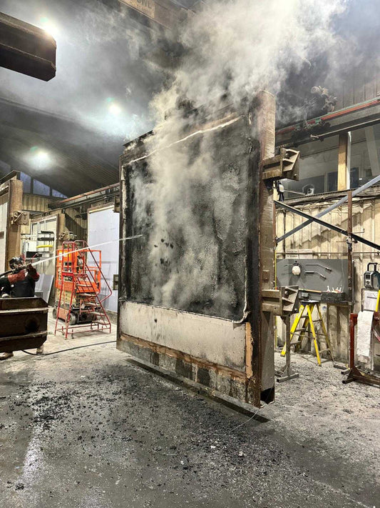 FRED-coated board resisting a direct flame in a burn test — charring to protect the material beneath instead of igniting