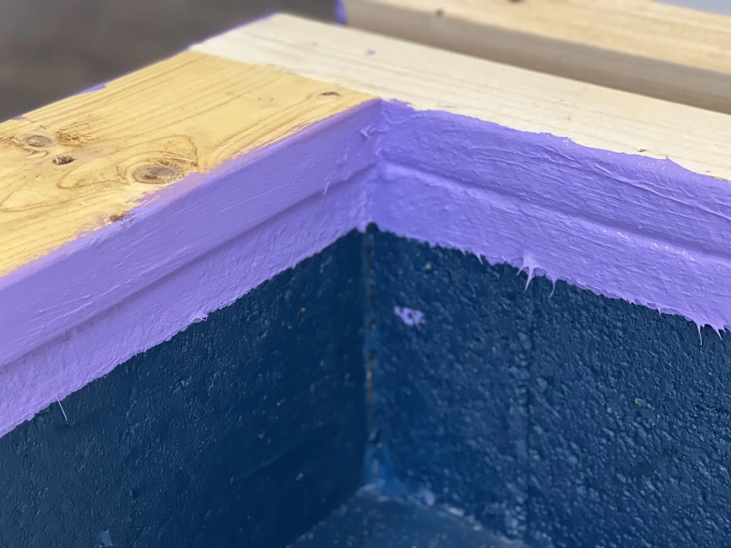 “Close-up of kicker block sealed with liquid damp proof membrane paint.”