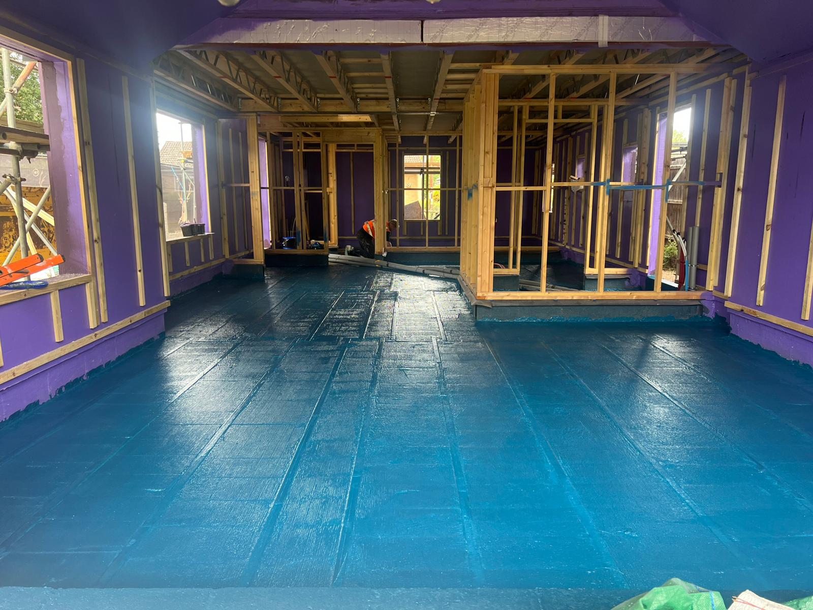 “Close-up of freshly applied liquid DPM forming a seamless waterproof barrier on concrete floor.”